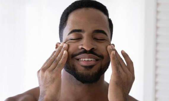 Man Smiling While Touching His Face